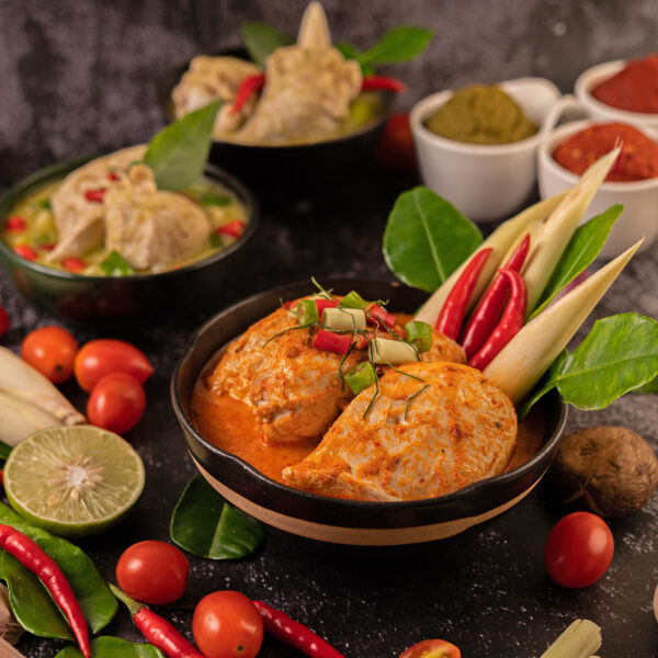 Chicken curry in a bowl with lemongrass, kaffir lime leaves, tom Chicken curry in a bowl with lemongrass, kaffir lime leaves, tom