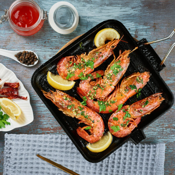 Grilled large queen shrimps with lemon and spices on the grill p